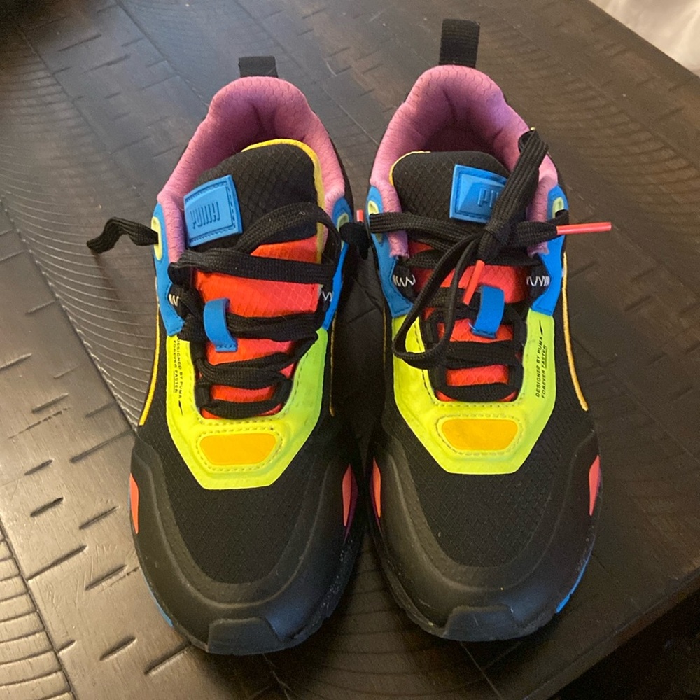 Kids Puma black in color with bright colors throughout